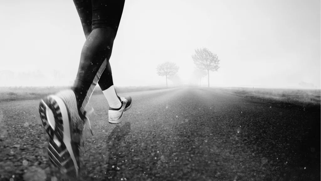 Runner moving along a road, symbolizing safe return to exercise after acupuncture treatment