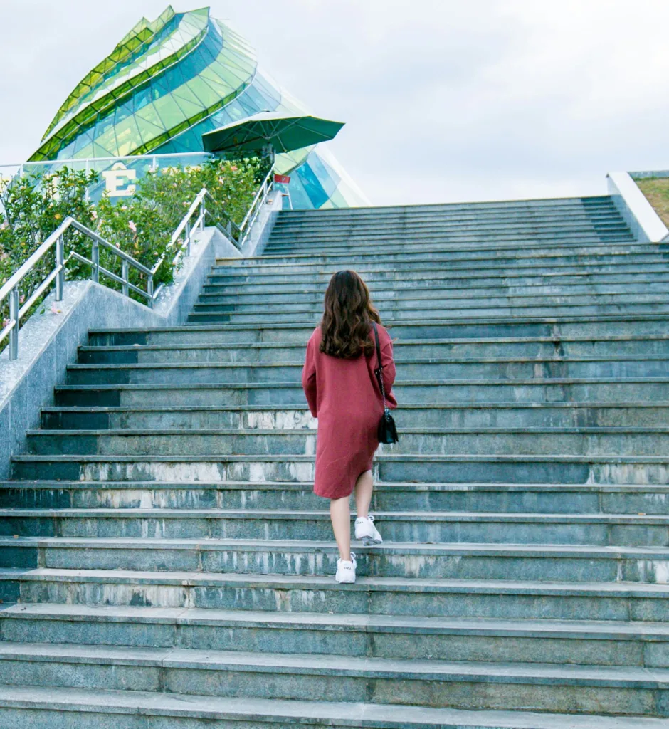 Person walking up stairs illustrating a common activity affected by knee pain