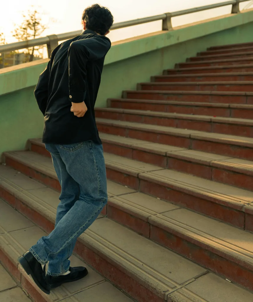 Person walking up stairs showing hip movement and weight shift – Big Easy Acupuncture Metairie LA